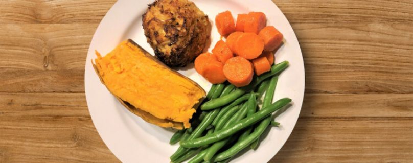 Crab Cake with half of a sweet potato, green beans, and carrots